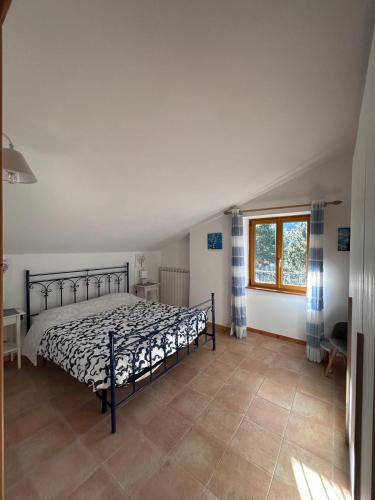 a bedroom with a bed and a window at Roccaraso Inn Blu in Roccaraso