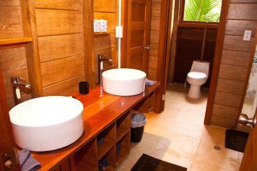 a bathroom with two sinks and a toilet at Residencia Natural in Bocas Town