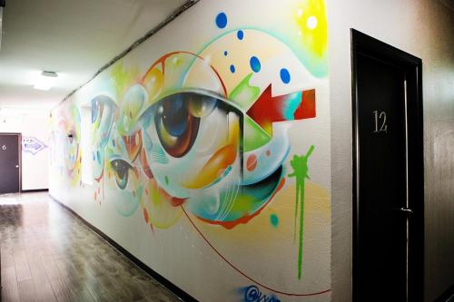 a wall with a painting of a eye on it at Samesun Hollywood in Los Angeles