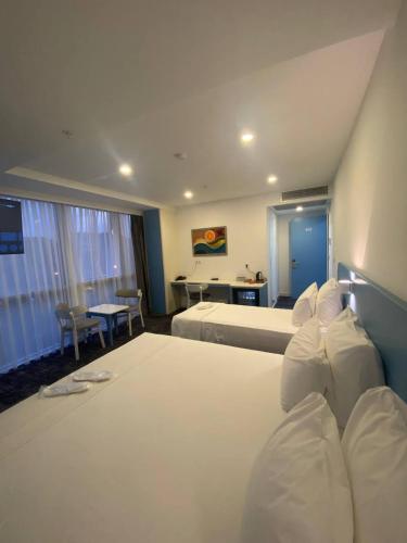 a hotel room with a large bed and a desk at No25 Hotels in Çorlu