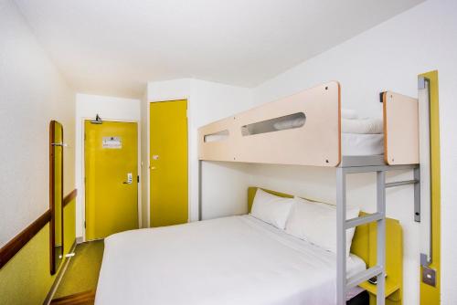 a small room with a bunk bed and a ladder at ibis Budget - St Peters in Sydney