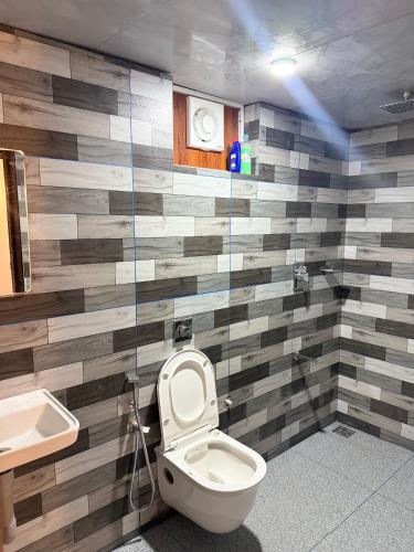 a bathroom with a toilet and a sink at Zerahs Private Pool Villa, Athirappilly - Extra upstair Bed space in Athirappilly