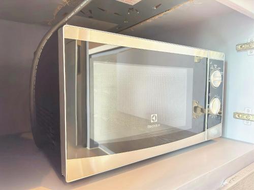 a microwave oven on display on a wall at Modern Urban Living Kamala in Kamala Beach