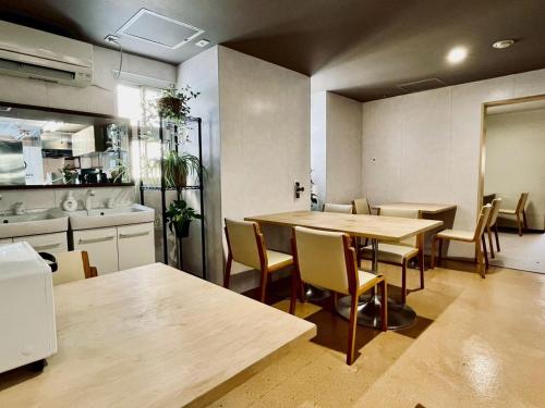 a room with a table and chairs and a kitchen at Yuzawa house2 in Yuzawa