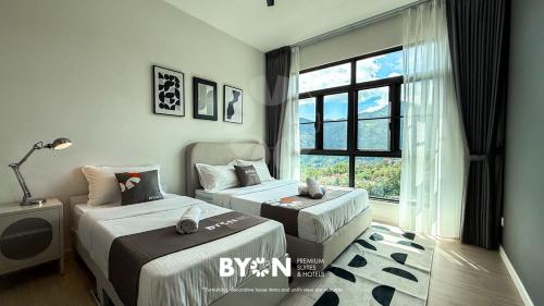 een slaapkamer met twee bedden en een raam bij Enclave Nature Suites @ Bukit Tinggi in Bentong