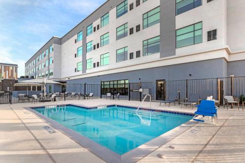 a swimming pool in front of a building at Cambria Hotel Northlake Conference Center - Roanoke in Northlake