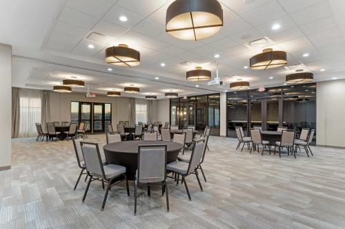 a conference room with tables and chairs and lights at Cambria Hotel Northlake Conference Center - Roanoke in Northlake
