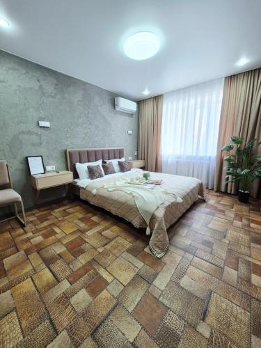 a bedroom with a large bed in a room at Отдых перед и до вылета самолёта in Astana