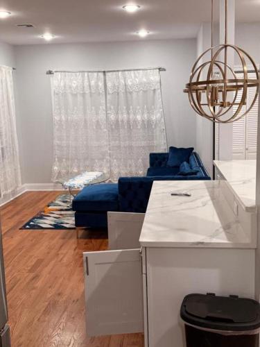 a living room with a blue couch and a table at The great homes in East Orange
