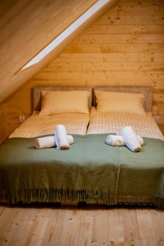 a bedroom with a bed with two pillows on it at Karmuszka Leśna Weranda in Łukta
