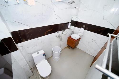 a bathroom with a toilet and a sink at Taj Holiday Villa in Agra