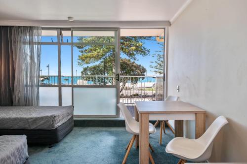 a bedroom with a bed and a desk and a window at Quality Inn Napier in Napier