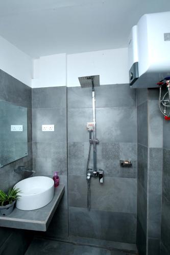 a bathroom with a shower with a tub and a sink at Kandy House Hiriketiya in Dickwella