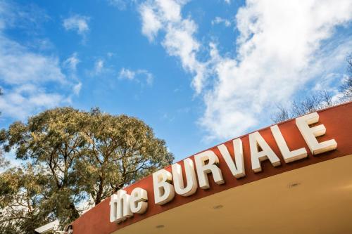 a sign on top of a building with trees at Burvale Hotel in Nunawading