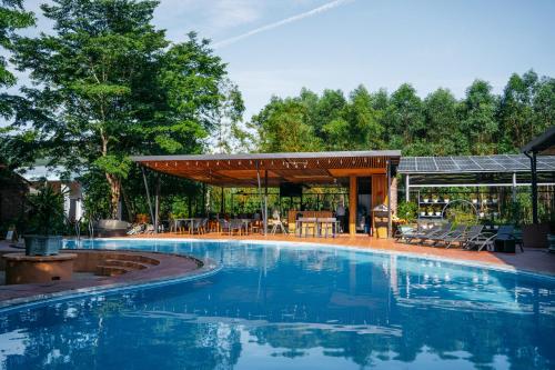 einen Pool mit Pavillon und ein Haus in der Unterkunft Chay Lap Farmstay Phong Nha in Ðá Lòn