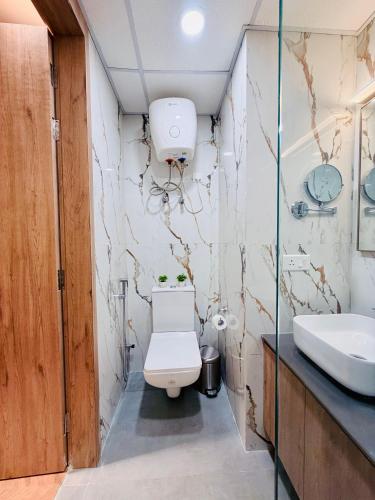 a bathroom with a toilet and a sink at StayWorks studios in Greater Noida