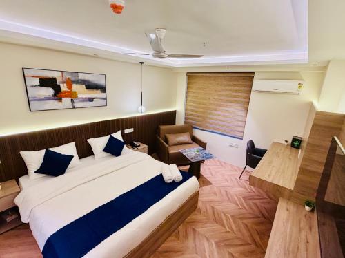 a hotel room with a bed and a chair at StayWorks studios in Greater Noida