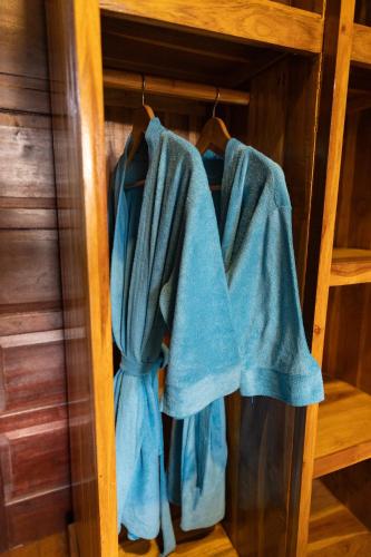 a pair of blue towels hanging on a shelf at The Pyramid Ubud River Villas in Gianyar