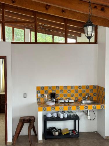 a kitchen with a counter and a table in a room at Casa Palomar in Guanajuato