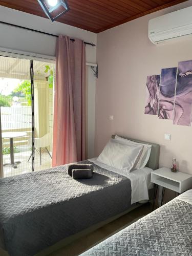 a bedroom with a large bed and a window at Dada's Cottage in Argyrádes