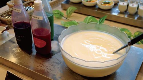 a bowl of food on a table with bottles of wine at Koriyama View Hotel Annex in Koriyama