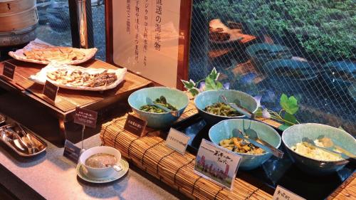 a buffet with bowls of food on a table at Koriyama View Hotel Annex in Koriyama
