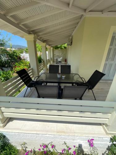 een patio met 2 stoelen en een tafel op een veranda bij Dada's Cottage in Argyrádes