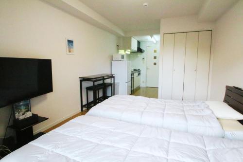 Giường trong phòng chung tại オンブラージュ九203