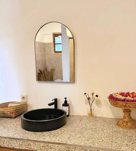 a bathroom with a black sink and a mirror at Little Munduk Villa A Private Mountain Escape in Munduk
