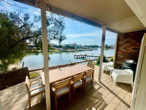 a porch with a view of the water at Mooloolaba Coastal Canal Villa in Mooloolaba