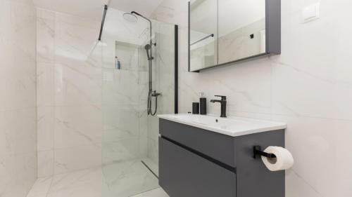 a bathroom with a sink and a shower at Star Hill - Makarska by Villas Guide in Slivno