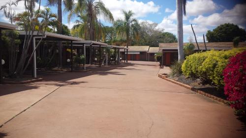 an empty sidewalk in front of a building at Cattleman's Rest Motor Inn in Charters Towers