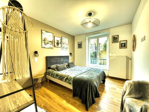 a bedroom with a bed and a window at Au Beau Duplex de la Basilique in Boulogne-sur-Mer