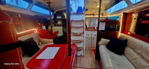 a living room with a couch and a table in an rv at Voilier de tout confort in Cherbourg en Cotentin