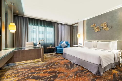 Postel nebo postele na pokoji v ubytování Aston Tropicana Hotel Bandung