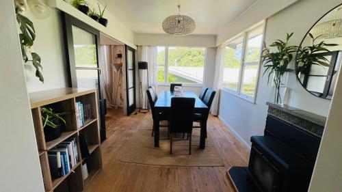 a dining room with a table and chairs at Stay on Stafford in Nelson