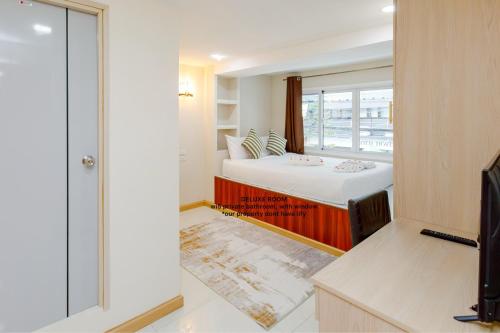 En eller flere senge i et værelse på PSA Palace Khaosan