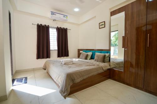 een slaapkamer met een bed en een groot raam bij One bedroom apartment in Indore