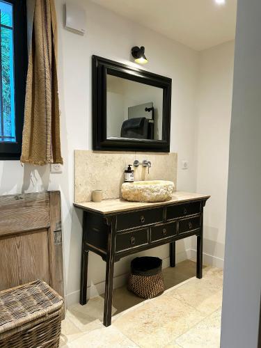 a bathroom with a sink and a mirror at Bastide Nomade - guest house in Saint Paul de Vence