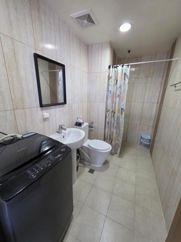 a bathroom with a sink and a toilet at 8 Adriatico Condominium 1BR in Sampong