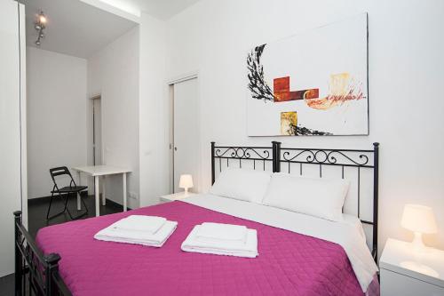 a bedroom with a large bed with a purple blanket at Cupola magica in Rome