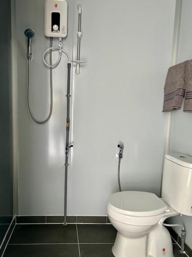 a bathroom with a shower and a toilet in it at TeeDo Zzz in Parit Buntar
