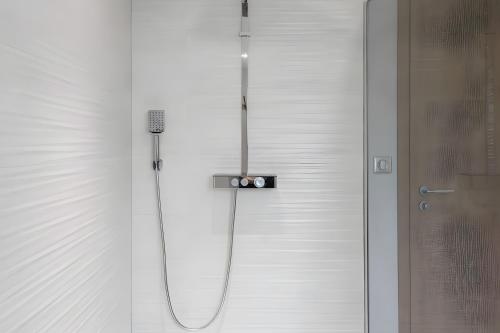 a shower with a microphone in a bathroom at Gîte Perce Neige, Spa, Sauna in Gerbépal