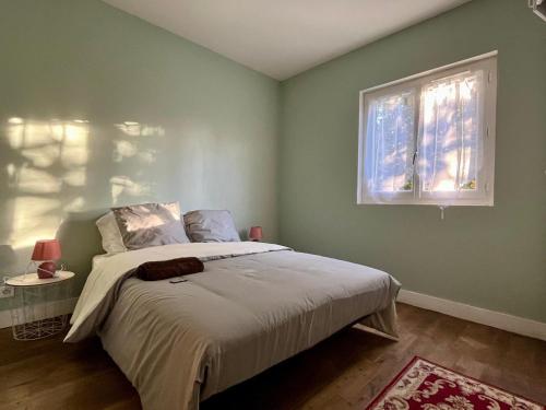 a bedroom with a bed and a window at Maison David in Le Buis