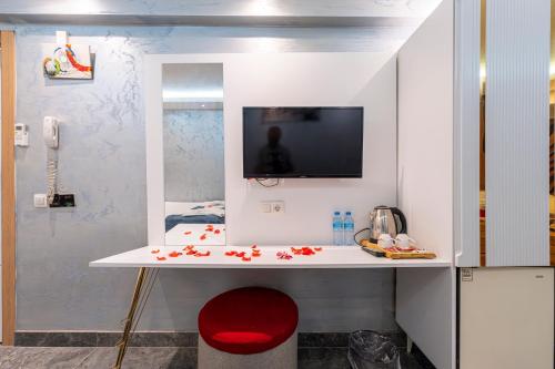 a room with a desk with a tv on a wall at Stay Suite Hotel in Istanbul