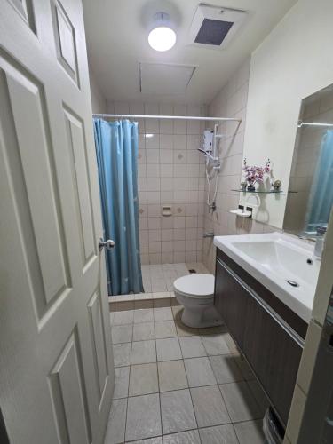 a bathroom with a toilet and a shower and a sink at Robinsons Place Residences Tower 1 in Sampong