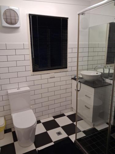 a bathroom with a toilet and a sink at Cartledge Ave studio and house homestay in Whyalla