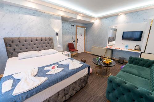 a bedroom with a bed and a couch and a table at Stay Suite Hotel in Istanbul