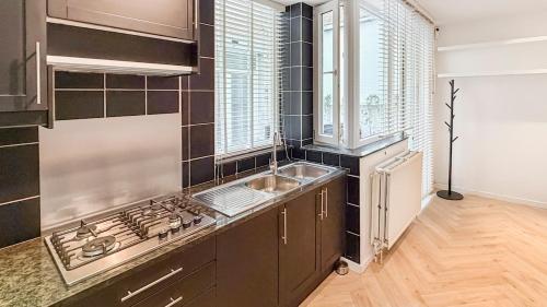 a kitchen with a sink and a stove top oven at Modern apartment near City Centre, Luna CasaMia in Mellet