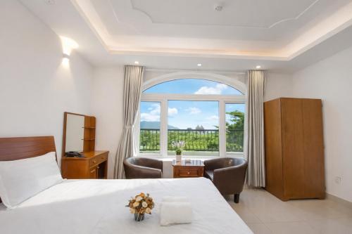 En eller flere senge i et værelse på Mio Hotel Vũng Tàu